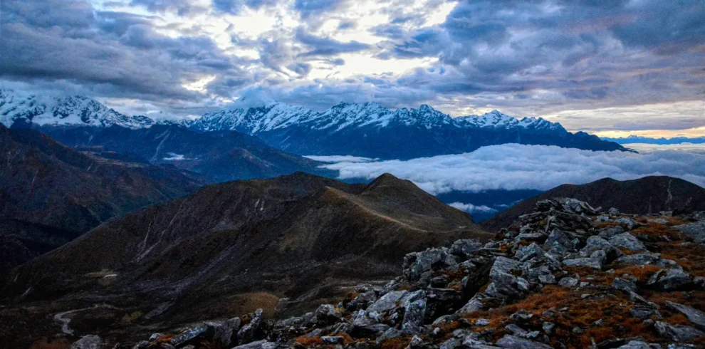 View from Danphebhir La on Uttarey–Singalila Circuit Trek with snow-capped Himalayas and cloud-covered valleys
