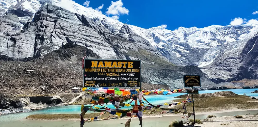 Colorful prayer flags at Panchakunda Lake marking Annapurna First North Base Camp, a route on the Annapurna Base Camp trek.