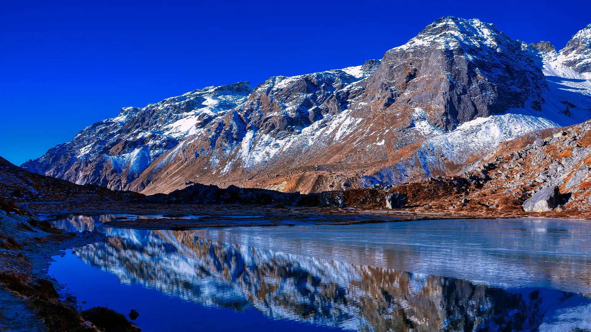 Scenic view of Uttarey town in West Sikkim with village houses set below lush mountain slopes.