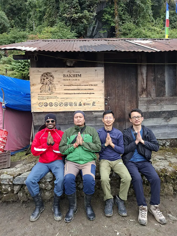 Experienced local trekking guides in Sikkim greeting with a Namaste at the Bakhim camp hut.