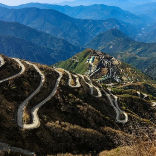 Winding hairpin bends of the historic Zuluk Silk Route traversing the scenic mountains of Sikkim.