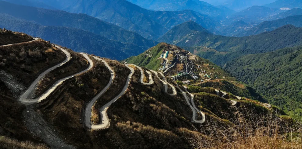 Winding hairpin bends of the historic Zuluk Silk Route traversing the scenic mountains of Sikkim.